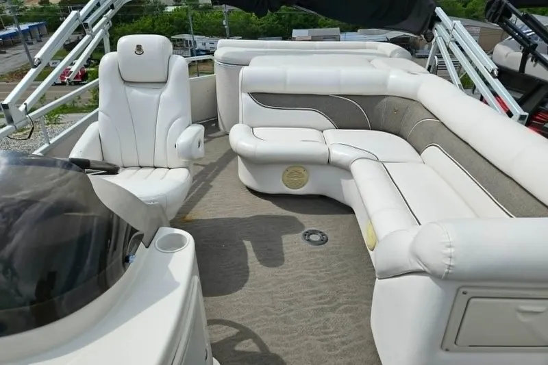 Slide: The Image of Luxurious seating on 2007 Premier 225 Legend RE pontoon boat, featuring plush white upholstery. - 2