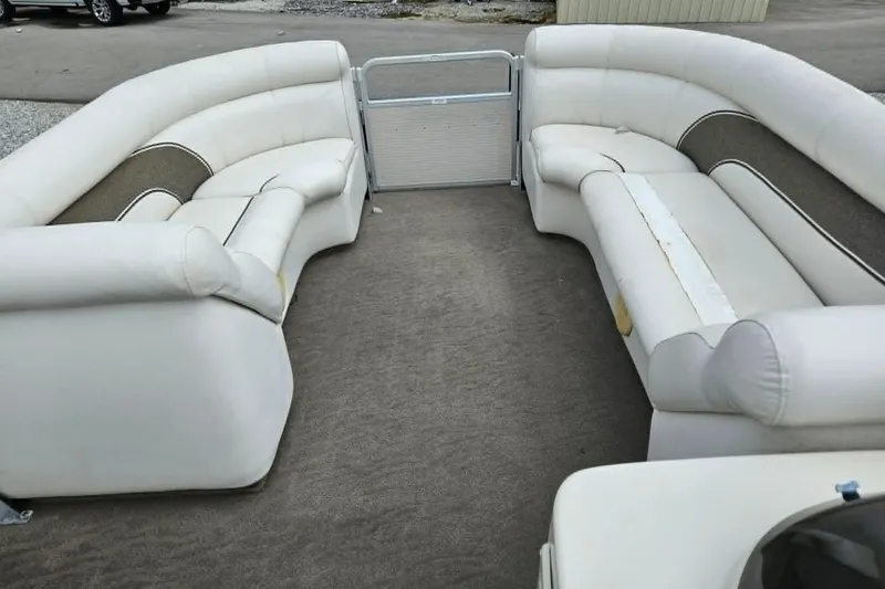 Slide: The Image of 2007 Premier 225 Legend RE pontoon boat interior with white seating and carpeted floor. - 5