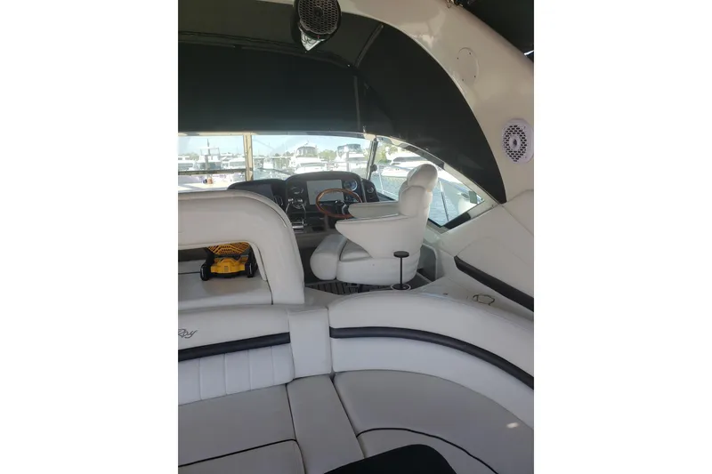 Slide: The Image of Interior view of a 2003 Sea Ray 420 Sundancer yacht with white seating and helm. - 10