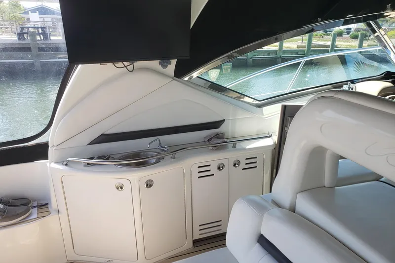 Slide: The Image of Interior of 2003 Sea Ray 420 Sundancer yacht with seating and kitchenette area. - 11