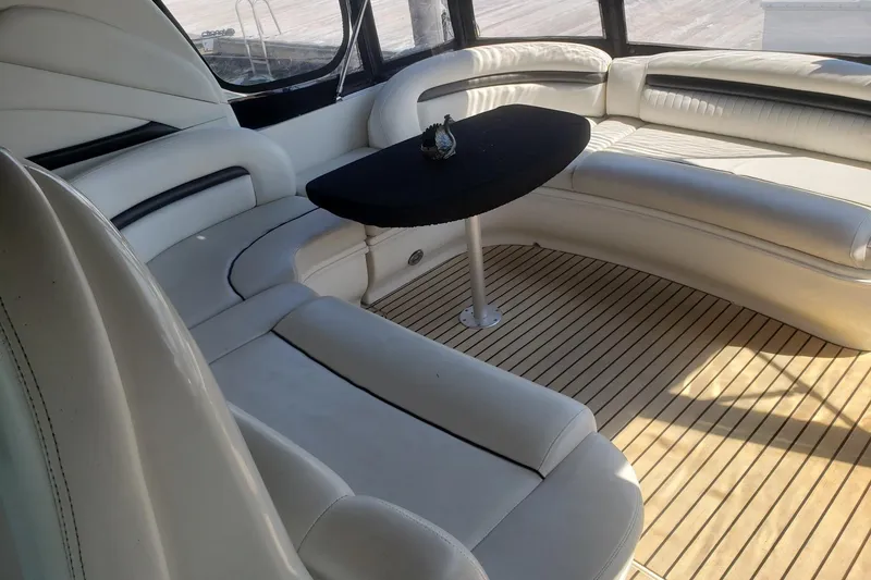 Slide: The Image of Luxurious interior of 2003 Sea Ray 420 Sundancer with elegant seating and table. - 12