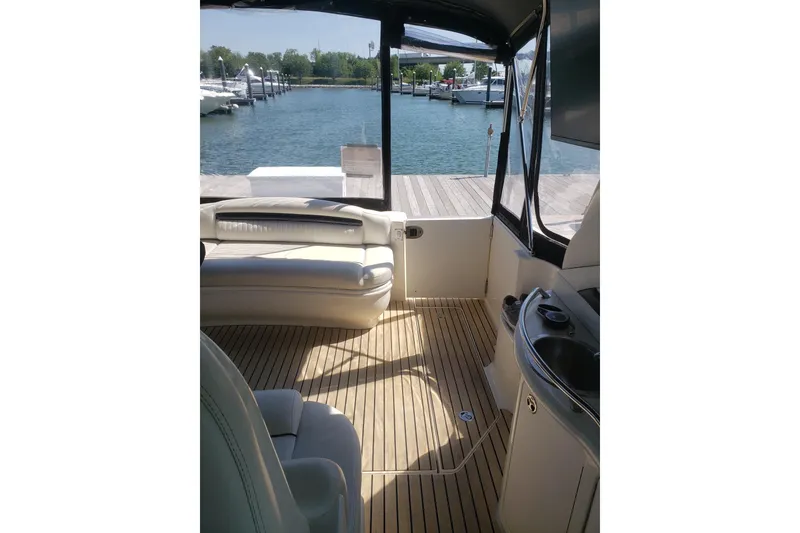 Slide: The Image of Interior view of 2003 Sea Ray 420 Sundancer yacht with dockside marina backdrop. - 13