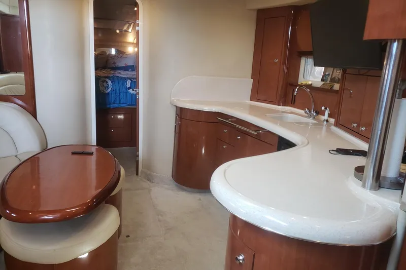 Slide: The Image of Interior of 2003 Sea Ray 420 Sundancer yacht with modern kitchen and seating area. - 15