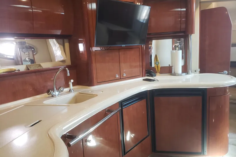 Slide: The Image of Luxurious 2003 Sea Ray 420 Sundancer yacht interior with modern kitchen amenities. - 16