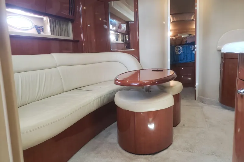 Slide: The Image of Luxurious interior of a 2003 Sea Ray 420 Sundancer yacht with elegant seating and table. - 18