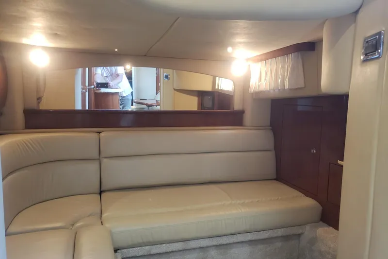 Slide: The Image of Interior of 2003 Sea Ray 420 Sundancer yacht with beige leather seating and wood accents. - 19