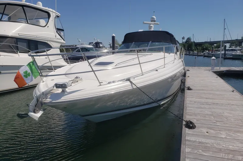 Slide: The Image of 2003 Sea Ray 420 Sundancer yacht docked at marina, sunny day, Irish flag displayed. - 2