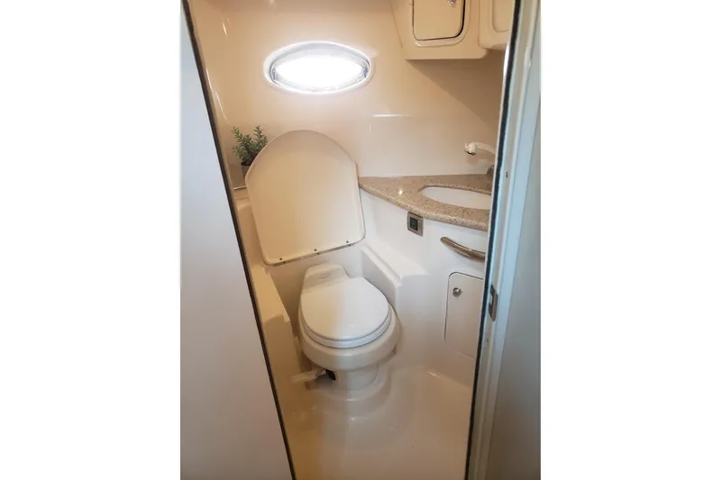 Slide: The Image of Bathroom interior of 2003 Sea Ray 420 Sundancer yacht with toilet and sink. - 25