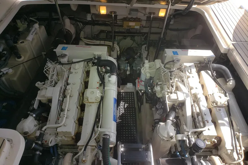 Slide: The Image of Engine room of 2003 Sea Ray 420 Sundancer with dual engines and mechanical components. - 27