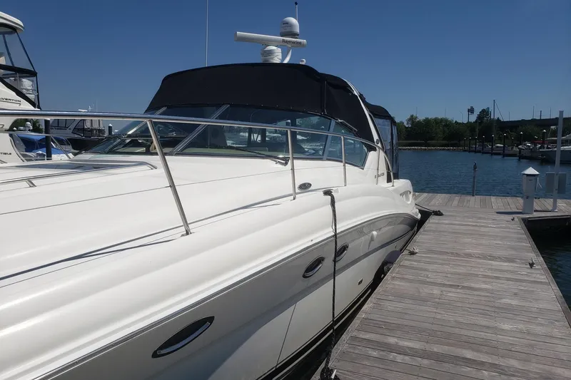 Slide: The Image of 2003 Sea Ray 420 Sundancer yacht docked at marina under clear blue sky. - 3