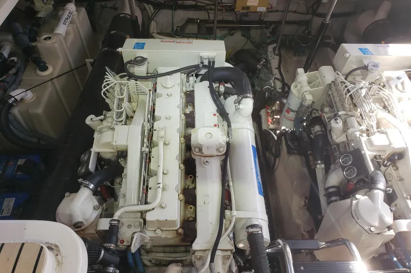 Slide: The Image of Engine room of a 2003 Sea Ray 420 Sundancer, showcasing dual marine engines. - 30