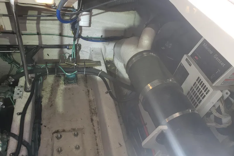 Slide: The Image of Engine room of 2003 Sea Ray 420 Sundancer with marine generator and piping. - 31
