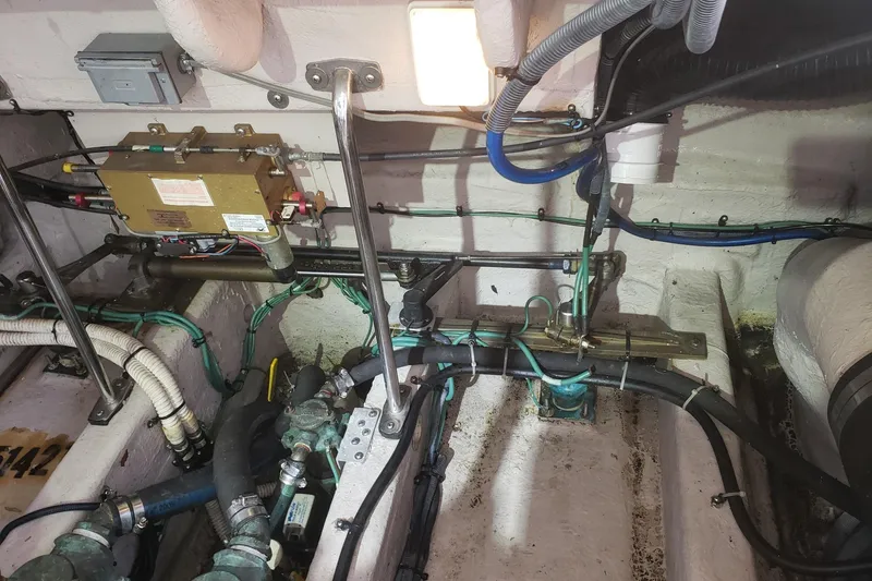 Slide: The Image of Engine room of a 2003 Sea Ray 420 Sundancer with visible wiring and components. - 32
