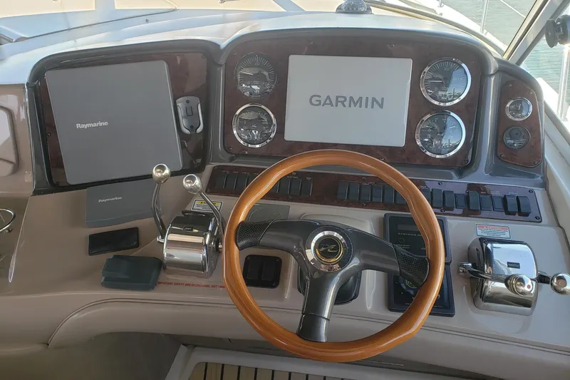 Slide: The Image of Helm of 2003 Sea Ray 420 Sundancer with Garmin and Raymarine navigation systems. - 6