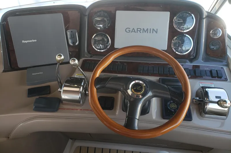 Slide: The Image of Control panel of a 2003 Sea Ray 420 Sundancer with Garmin and Raymarine displays. - 8