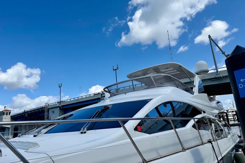Slide: The Image of Luxury Azimut 60 yacht from 2013 docked under a clear blue sky. - 24