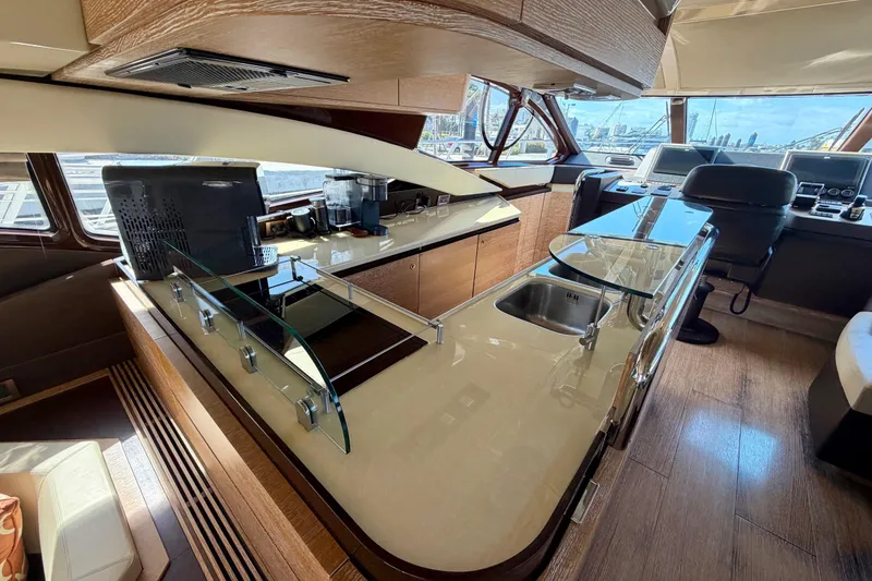 Slide: The Image of Luxurious interior of a 2013 Azimut 60 yacht with modern kitchen and navigation area. - 28