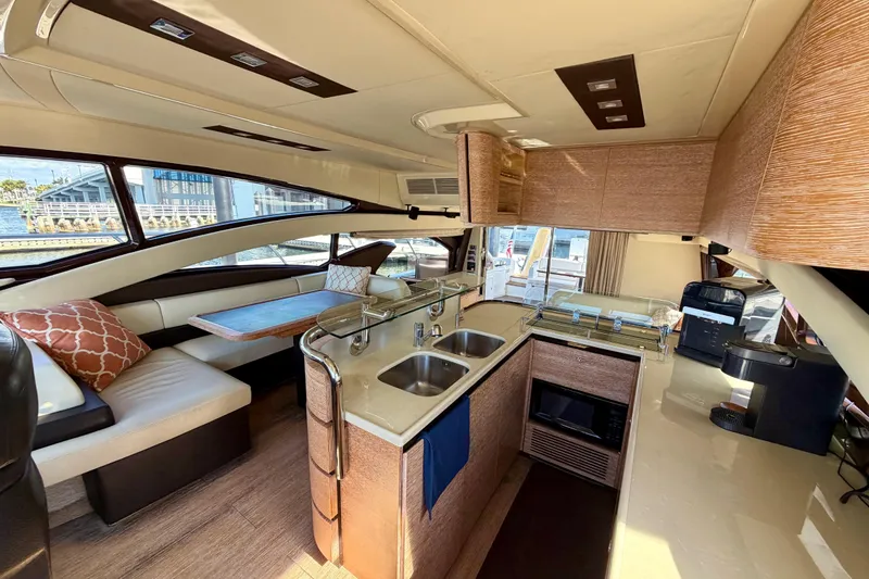 Slide: The Image of Luxurious interior of a 2013 Azimut 60 yacht featuring a modern kitchen and dining area. - 29