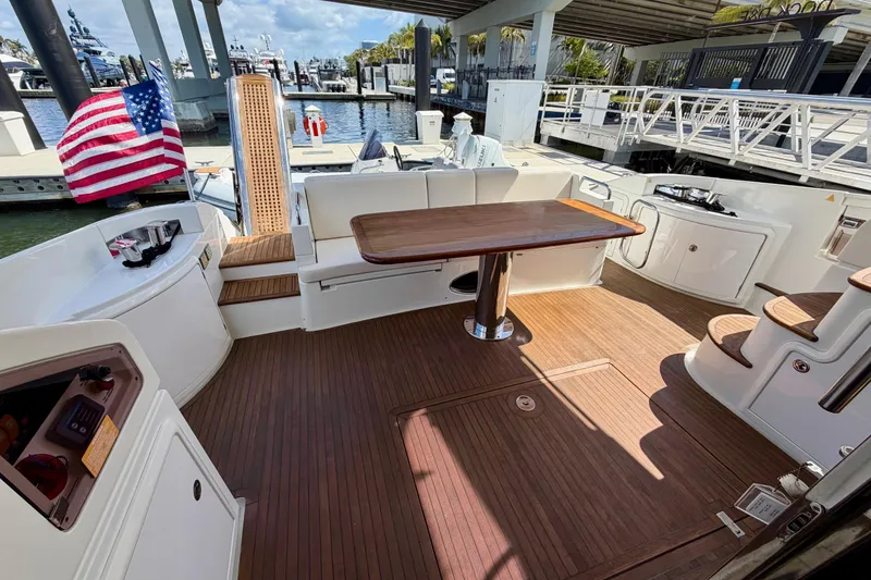 Slide: The Image of Luxurious 2013 Azimut 60 yacht deck with wooden flooring and seating area. - 34