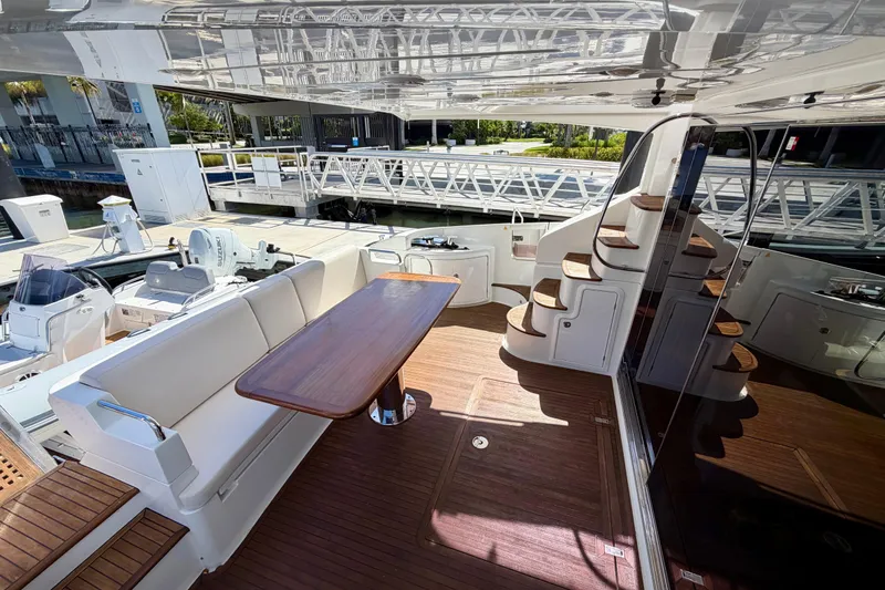 Slide: The Image of Luxurious 2013 Azimut 60 yacht deck with seating and wooden table. - 35