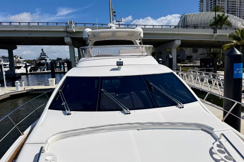 Slide: The Image of Front view of a 2013 Azimut 60 yacht docked at a marina under a bridge. - 36