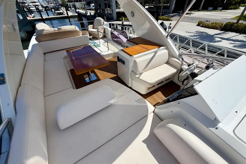 Slide: The Image of Luxurious 2013 Azimut 60 yacht deck with plush seating and wooden table. - 38