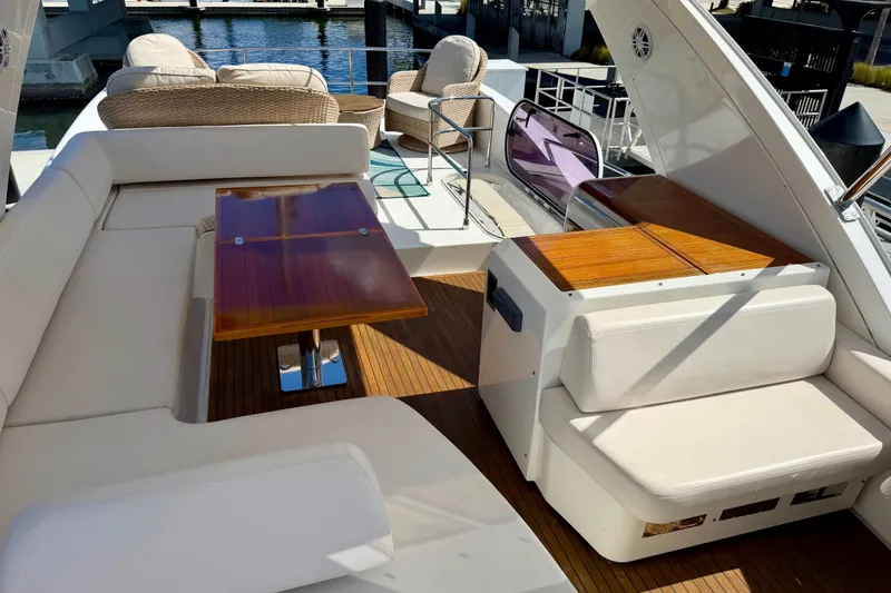 Slide: The Image of Luxurious seating area on a 2013 Azimut 60 yacht with wooden table and waterfront view. - 39