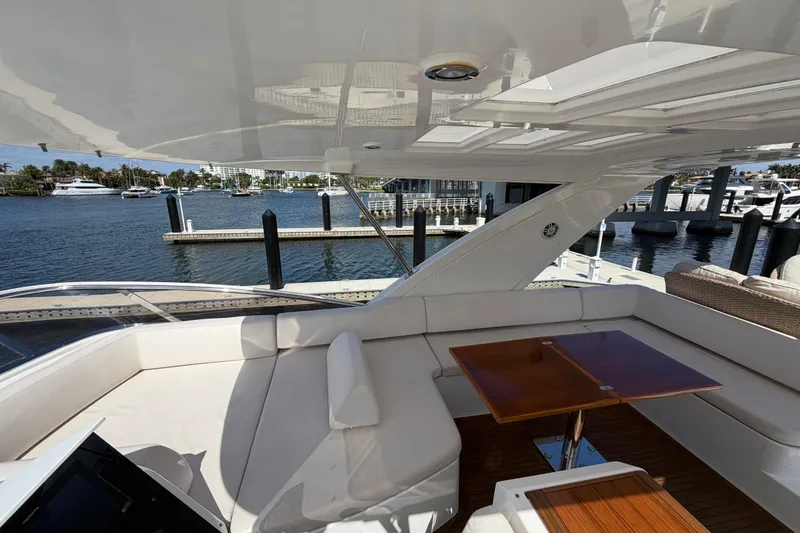 Slide: The Image of Luxurious 2013 Azimut 60 yacht interior with elegant seating and wooden table, docked at marina. - 40