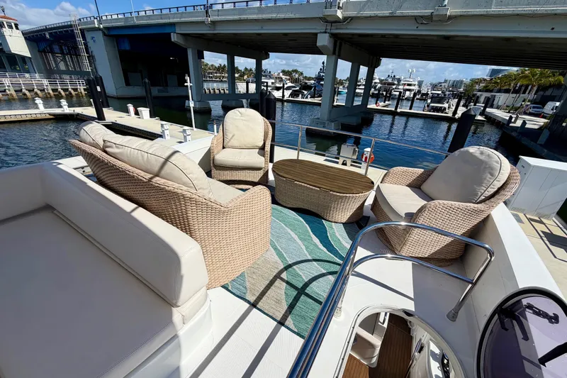 Slide: The Image of Luxurious seating area on 2013 Azimut 60 yacht, docked under a bridge. - 44