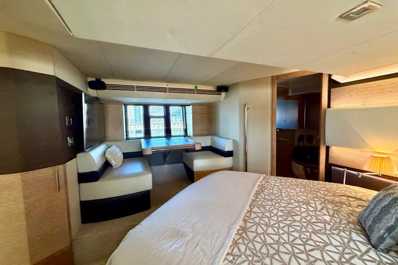 Slide: The Image of Luxurious interior of a 2013 Azimut 60 yacht featuring a cozy bedroom and seating area. - 46