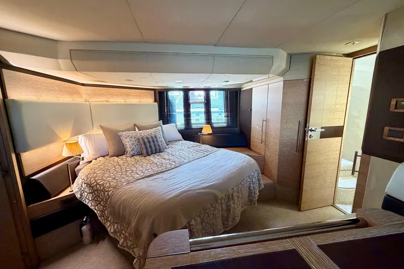 Slide: The Image of Luxurious bedroom interior of a 2013 Azimut 60 yacht with elegant bedding and ambient lighting. - 48