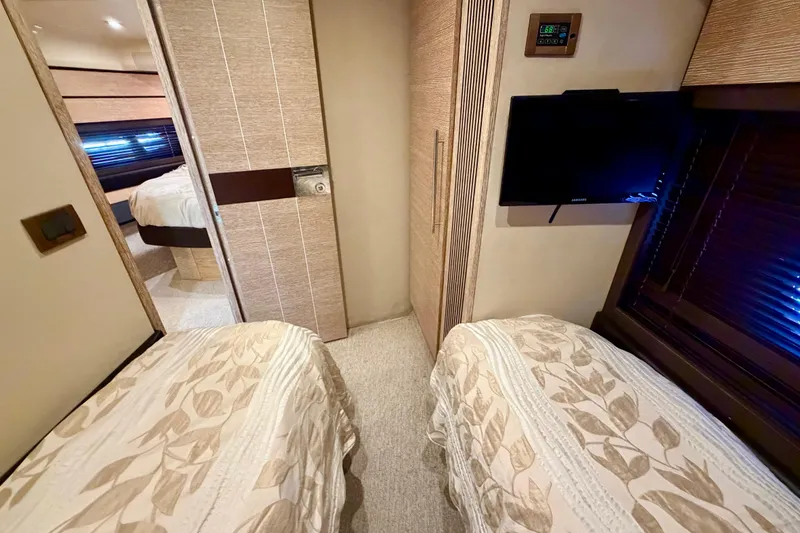 Slide: The Image of Interior of 2013 Azimut 60 yacht with twin beds and wall-mounted TV. - 52