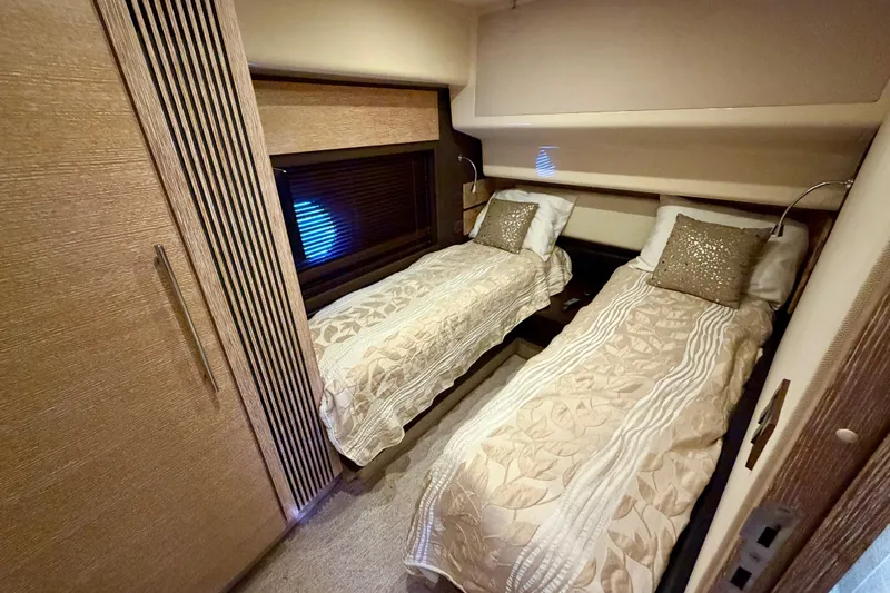 Slide: The Image of Luxurious twin cabin interior of 2013 Azimut 60 yacht with elegant bedding and wood finishes. - 54