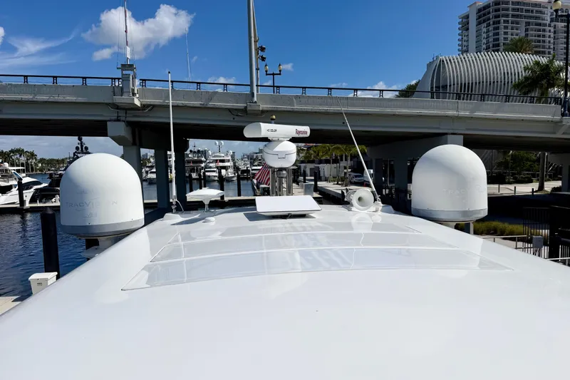 Slide: The Image of Azimut 60 yacht (2013) docked near a bridge, featuring radar and satellite equipment. - 56