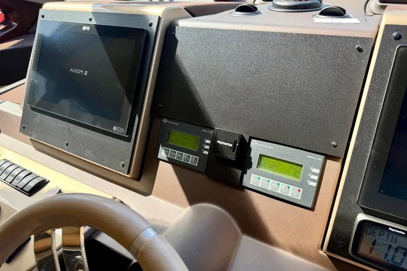 Slide: The Image of Control panel of a 2013 Azimut 60 yacht featuring navigation and monitoring systems. - 58