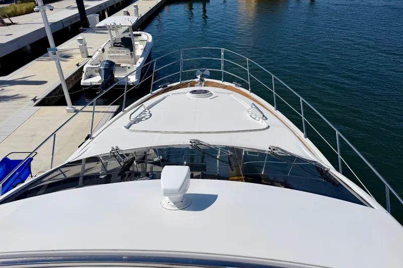 Slide: The Image of Bow view of a 2013 Azimut 60 yacht docked at a marina. - 63