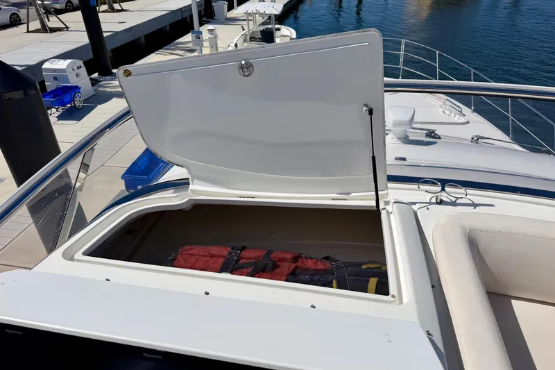 Slide: The Image of Open storage compartment on 2013 Azimut 60 yacht, docked at marina. - 64