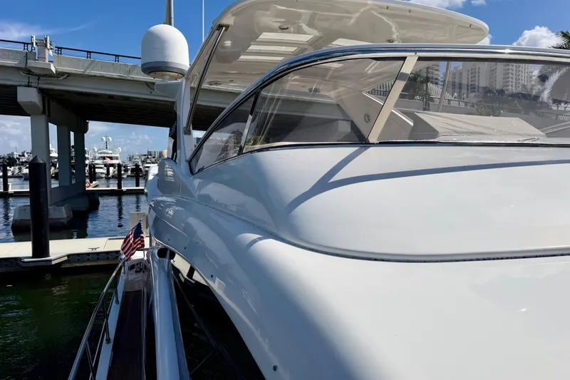 Slide: The Image of 2013 Azimut 60 yacht docked near a bridge, showcasing sleek design and luxury. - 65
