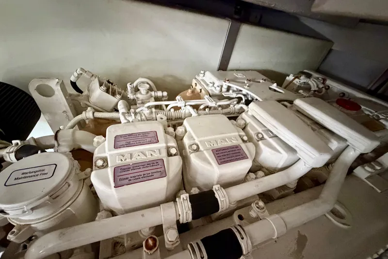 Slide: The Image of Engine compartment of a 2013 Azimut 60 yacht, featuring a MAN engine. - 69