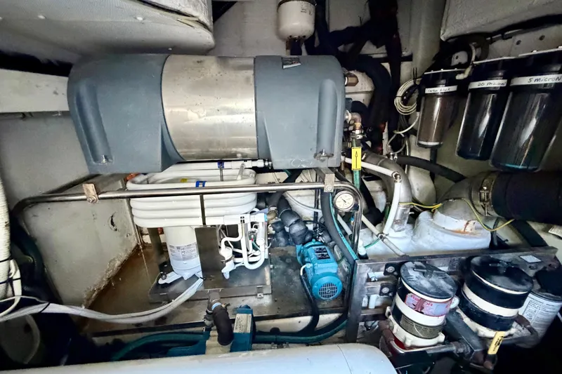 Slide: The Image of Engine room of a 2013 Azimut 60 yacht, showcasing mechanical components and filtration systems. - 71