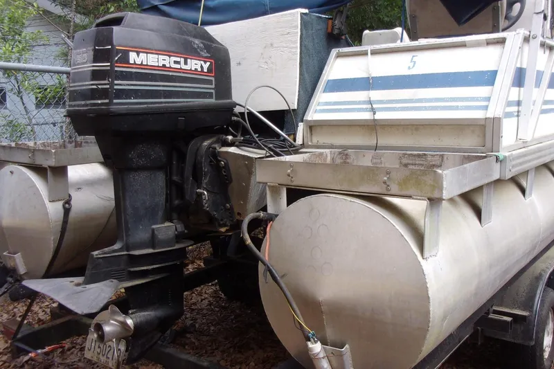 Slide: The Image of 1997 Aloha FISH N PARTY boat with Mercury outboard motor, docked and ready for adventure. - 4