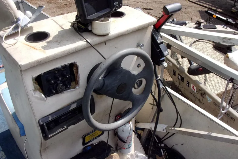 Slide: The Image of Steering console of a 1997 Aloha FISH N PARTY boat with equipment and controls. - 5
