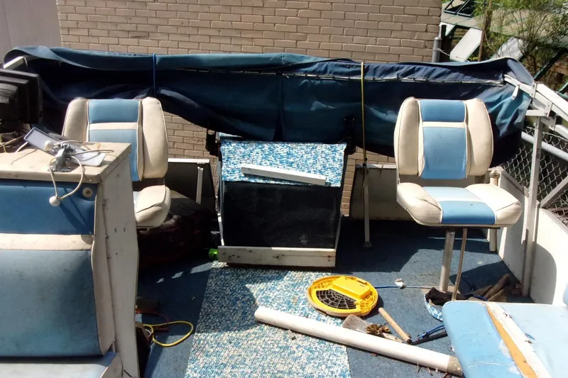 Slide: The Image of 1997 Aloha FISH N PARTY boat interior with blue seats and equipment. - 6