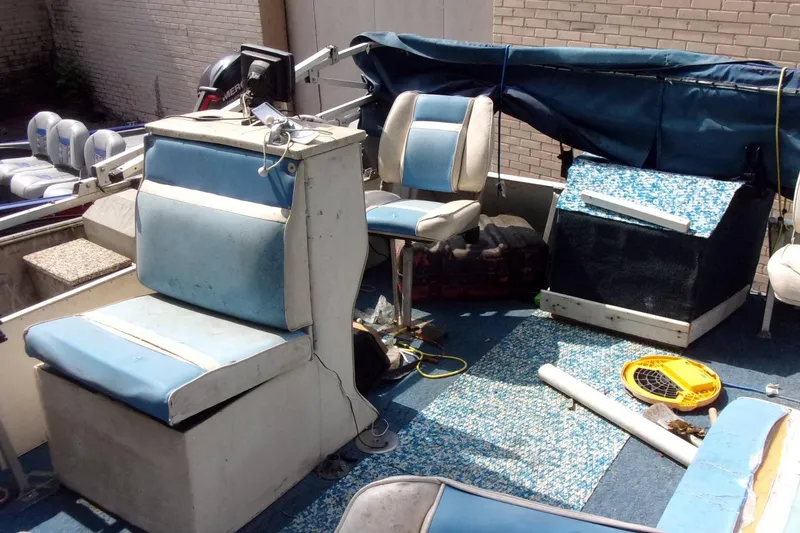 Slide: The Image of 1997 Aloha FISH N PARTY boat interior with blue seating and equipment. - 7