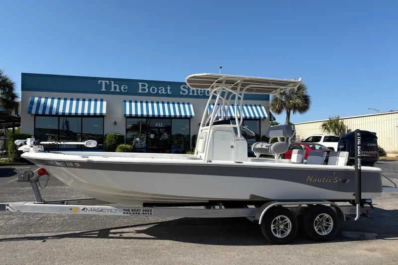 The Image of 2021 NauticStar 227 XTS boat on trailer outside The Boat Shed dealership. - 0
