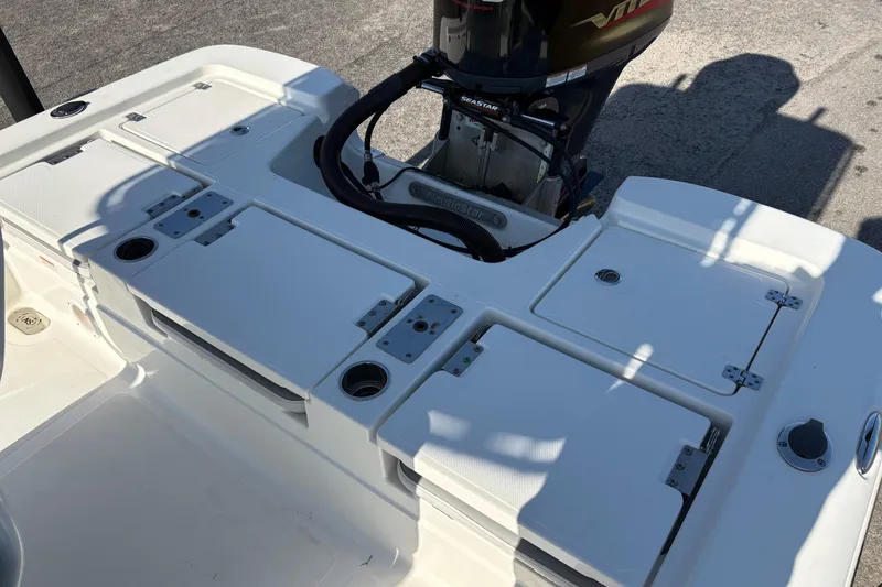 Slide: The Image of 2021 NauticStar 227 XTS boat deck with storage compartments and motor. - 10