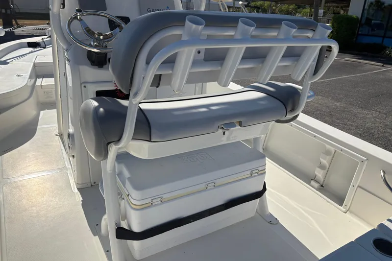 Slide: The Image of 2021 NauticStar 227 XTS boat interior with rod holders and cooler storage. - 11