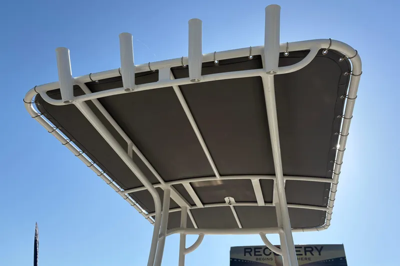 Slide: The Image of T-top of 2021 NauticStar 227 XTS boat against clear blue sky. - 12