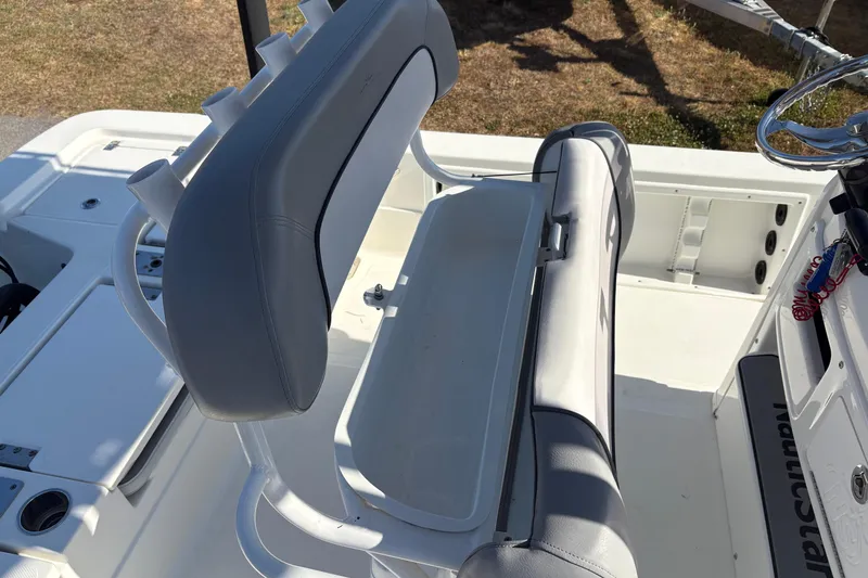 Slide: The Image of 2021 NauticStar 227 XTS boat interior with seating and steering wheel. - 14