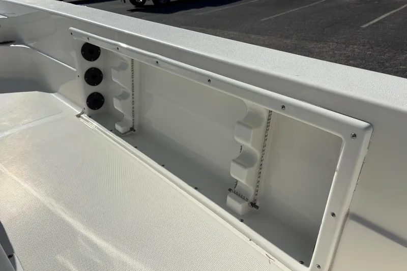 Slide: The Image of 2021 NauticStar 227 XTS boat interior with rod holders and storage compartment. - 20